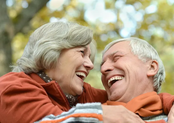 Smiling older couple looking at each other outdoors